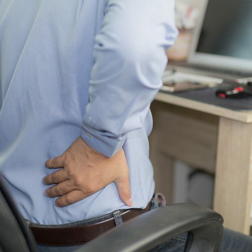 man holding his back in pain